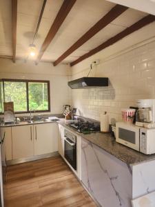 a kitchen with a sink and a stove top oven at Finca Agroturística La Amistad in Churuquita Grande