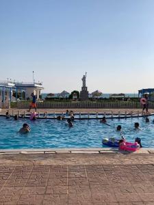 a group of people swimming in a swimming pool at Wonder Land Hotel in Ras Sedr