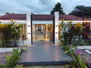 a front door of a house with plants at Casa Hotel AeroClubR15 in Villavicencio +6 photos