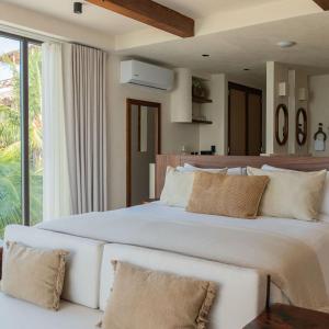 Un pat sau paturi într-o cameră la Hotel Boutique Casa Muuch Holbox