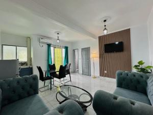 a living room with a couch and a table at Loft Residence in Douala