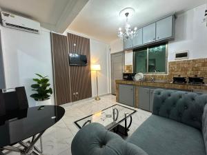a living room with a couch and a table at Loft Residence in Douala +7 photos