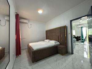 a bedroom with a bed and a large mirror at Loft Residence in Douala