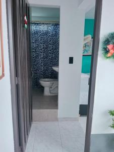 a bathroom with a toilet and a sink at Casa Hotel El Eden in Carepa +15 photos