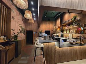 a bar in a restaurant with a counter and chairs at Hotel Stratford San Francisco - Handwritten Collection in San Francisco
