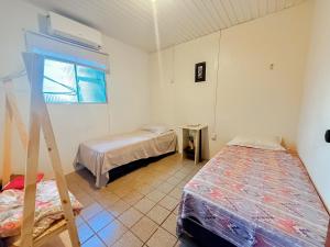 Ένα ή περισσότερα κρεβάτια σε δωμάτιο στο Pousada Varanda