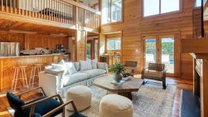 a living room with a couch and a table at Raven by AvantStay Entertainers Dream w Pool Hot Tub Game Room 9 BRs in Sullivans Island