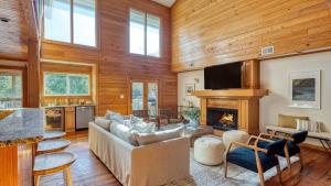 a living room with a couch and a fireplace at Raven by AvantStay Entertainers Dream w Pool Hot Tub Game Room 9 BRs in Sullivans Island