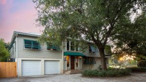 a house with a tree in front of it at Raven by AvantStay Entertainers Dream w Pool Hot Tub Game Room 9 BRs in Sullivans Island
