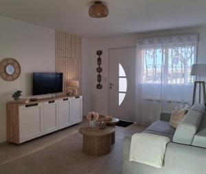 a living room with a blue couch and a tv at Ch'ti Camargue in Port-Saint-Louis-du-Rhône