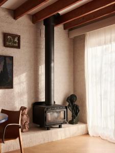 a fireplace in a living room with a stove at Cosy Cottage in North Fitzroy in Melbourne