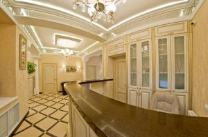 a large kitchen with a counter and a chandelier at Hotel Svetlitsa in Vologda