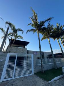 a building with palm trees in front of it at Suíte Harry Potter - Pousada Castelo do Luar in Penha