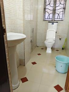 a bathroom with a sink and a toilet at JM Niwas in Guwahati