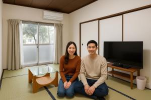 a man and a woman sitting in a living room at さんこ戸建て1号棟 in Takamatsu