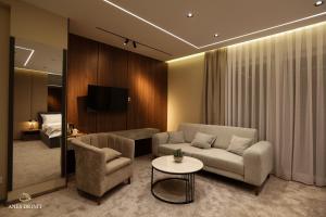 a living room with a couch and a table at Resort Anes Drinit in Peje
