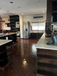 a kitchen with stainless steel appliances and a wooden floor at Magnifique appartement villa in Martil