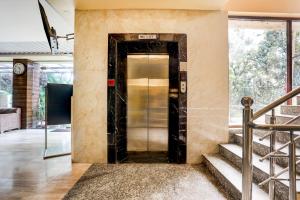 a elevator in the lobby of a building at Townhouse Oak Pacify Hills in Dehradun