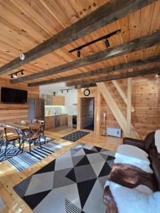 a living room with a wooden ceiling and a table at Villa Jelterra in Uskoci
