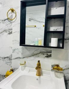 a bathroom with a white sink with a mirror at Wadirum Leen camp in Wadi Rum