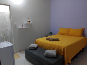 a bedroom with a bed with two stuffed animals on it at hospedaria Cantinho da Rosa in Santo Amaro
