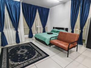 a bedroom with blue curtains and a bed and a chair at De Centrum Residences in Kajang