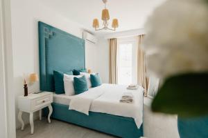 a blue and white bedroom with a bed and a window at Apartments Captain's Villa in Budva +65 photos