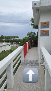 a sign on a building with an arrow on the sidewalk at Los Roires Beach Apartments in Fajardo