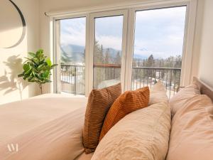 a bedroom with a bed with a large window at Oso Skyview Suite - DT modern 2 bed, 2 bath in Golden