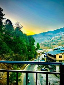 a view from a balcony of a city with a road at Askari Lodges Murree in Murree +8 photos