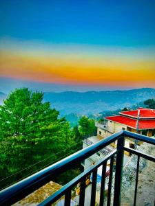 a view of the mountains from a balcony at Askari Lodges Murree in Murree +8 photos