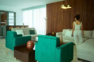 a woman in a white dress standing in a living room at Casa Orbit AC Pool Jacuzzi Central Location in Oaxaca City