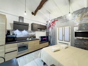 a kitchen with a large bed in a room at Centro storico- Suite silenziosa, Wi-Fi & Netflix in Varese