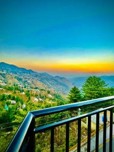 a view of a valley from a balcony at Askari Lodges Murree in Murree +7 photos