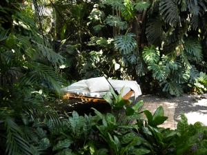 a bed in the middle of a forest at Nalu Nosara Pool Villa Sombra in Nosara