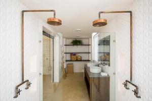 a bathroom with two sinks and a mirror at Nalu Nosara Pool Villa Jardin in Nosara