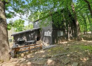 a building with a grill and a bench in a yard at Fayetteville Getaway - Near Campus and Dickson in Fayetteville
