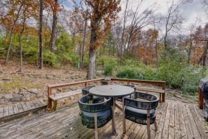 a table and two chairs on a wooden deck at Fayetteville Getaway - Near Campus and Dickson in Fayetteville