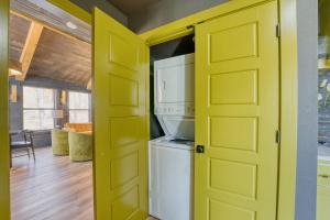 a kitchen with a yellow door and a refrigerator at Fayetteville Getaway - Near Campus and Dickson in Fayetteville +31 photos