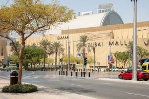a shopping mall with a red car parked in front of it at Stunning One bed Dubai mall downtown in Dubai