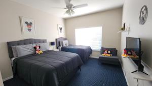 a bedroom with two beds and a flat screen tv at My Home in Orlando in Kissimmee +55 photos