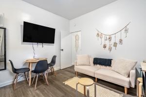 a living room with a couch and a table at The Ultimate NYC Base 1BR near Times Sq & Columbus Circle in New York