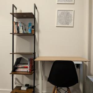 a desk with a chair next to a book shelf at The Bellagio NYC in New York