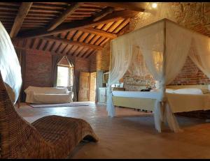 a bedroom with a bed with a canopy at Morami Wine Agriturismo in Panicarola
