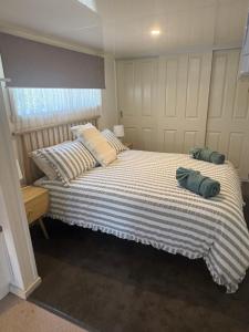 a bedroom with a bed with two pillows on it at Turners Beach Holiday Cabin in Turners Beach