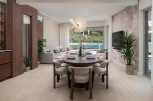 a living room with a dining room table and chairs at Luxury villa Zara, first row to the sea! in Kali