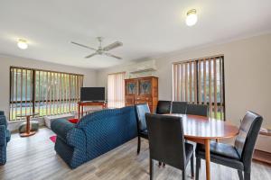 a living room with a table and a couch at Pet Friendly in Port Elliot in Port Elliot