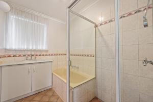 a bathroom with a shower and a sink and a tub at Pet Friendly in Port Elliot in Port Elliot +15 photos