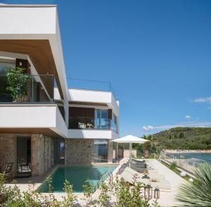 an image of a house with a swimming pool at Luxury villa Zara, first row to the sea! in Kali