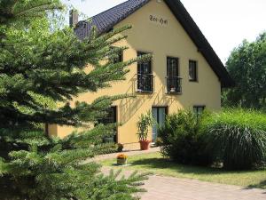 a yellow house with a tree in front of it at Carol's Country-House in Seehof